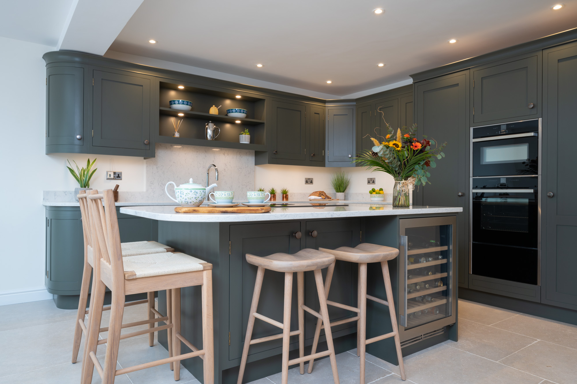 Contemporary handmade shaker kitchen by Holme Tree with dark painted cabinetry, central island seating, integrated wine cooler, and bespoke storage solutions.