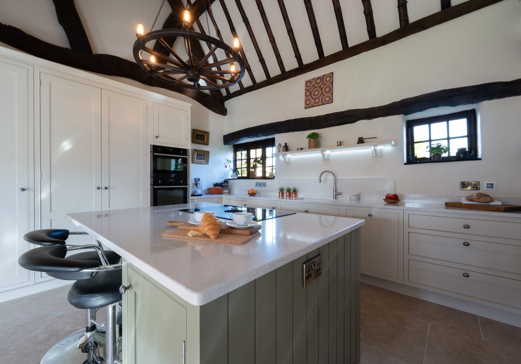 Handmade shaker kitchen with vaulted ceiling, painted island and exposed timber beams in a Leicestershire farmhouse